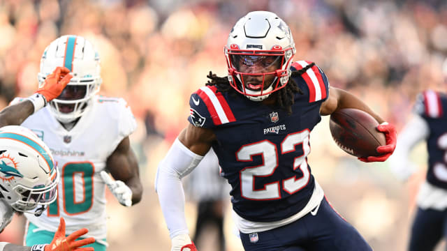 Jan 1, 2023; Foxborough, Massachusetts, USA; New England Patriots safety Kyle Dugger (23) runs for a touchdown after intercepting the ball during the second half of agame against the Miami Dolphins at Gillette Stadium.